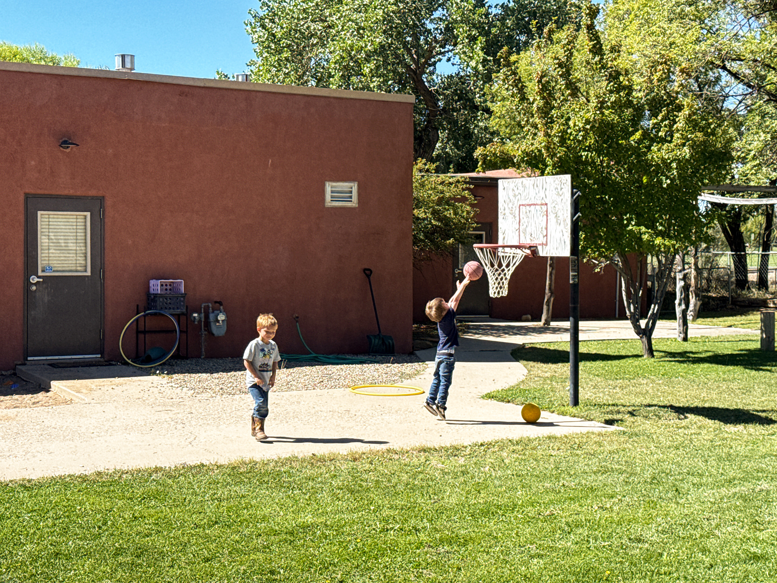 Children playing basketball on the Children's Kiva playground
